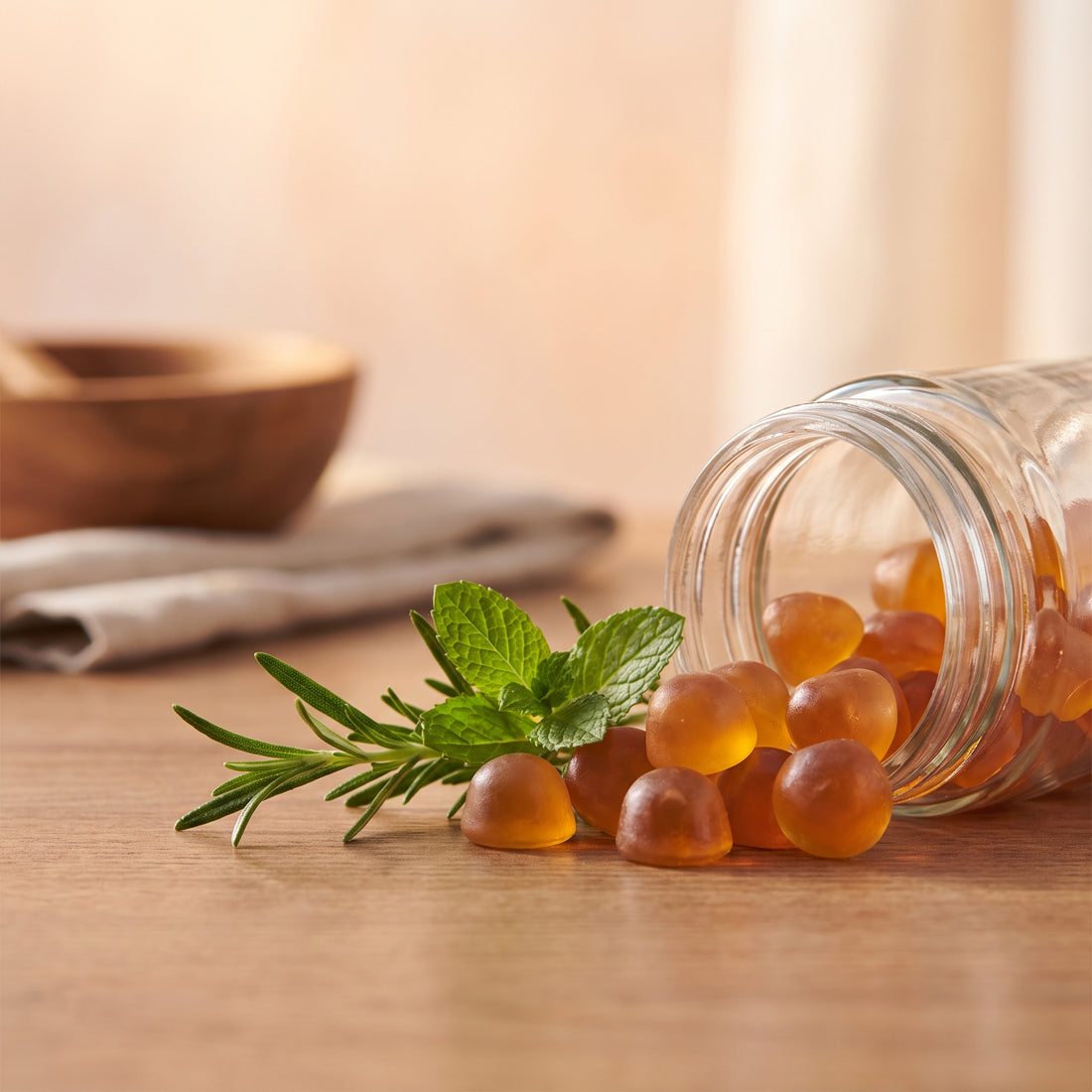 Golden gummies with a sprig of greenery, warm macro